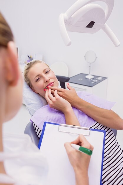 Female patient with toothache in clinic