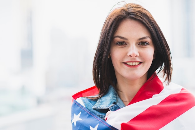 Female patriot wrapped in American flag