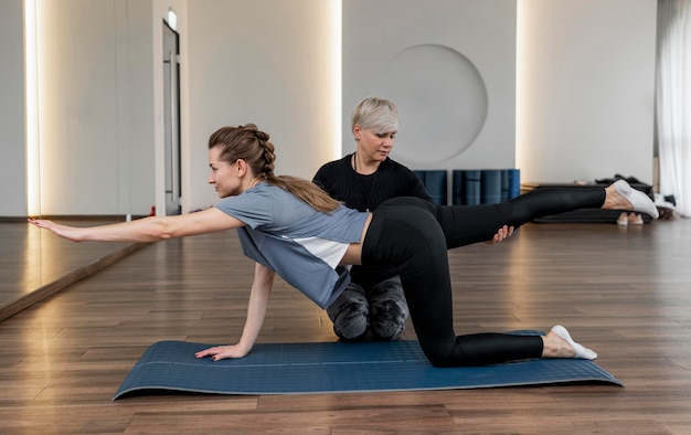 Female personal trainer helping her client long view