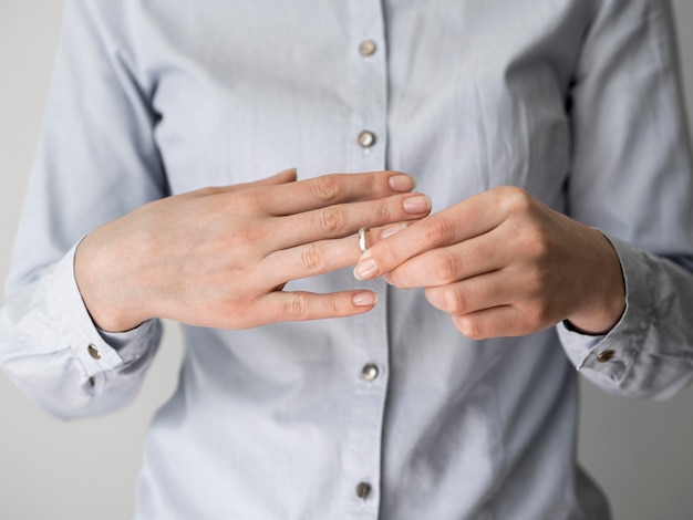 Free photo female pulling off marriage ring