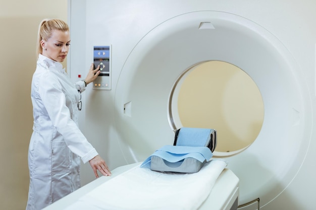 Free photo female radiologist preparing ct scanner for medical examination of a patient