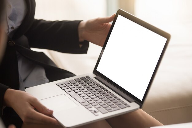 Female real estate agent showing house plan on laptop screen