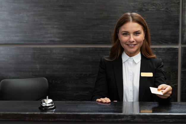 Free photo female receptionist in elegant suit during work hours