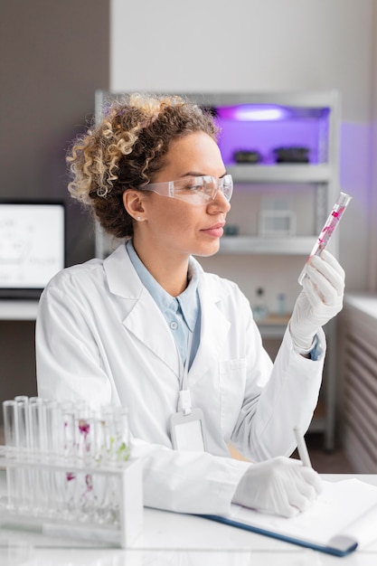 Female researcher in the laboratory with test tubes