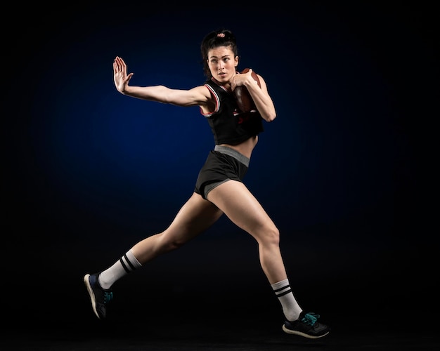 Female rugby player in sportswear posing