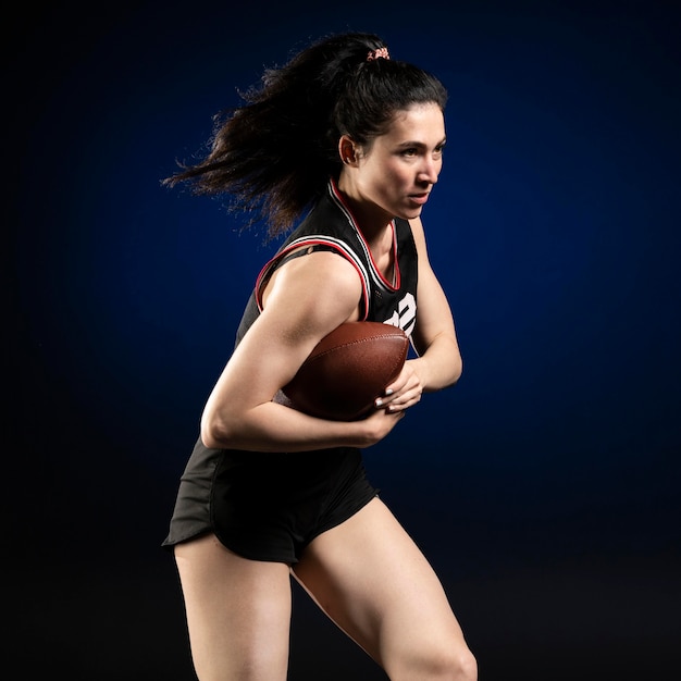 Female rugby player in sportswear posing