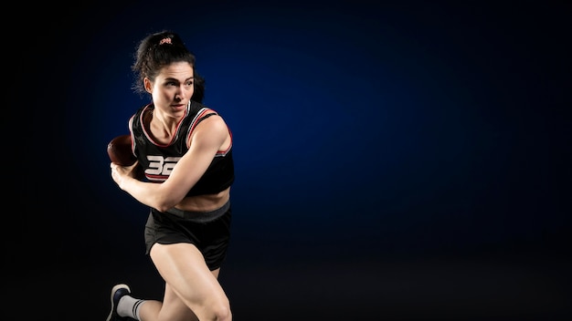 Female rugby player in sportswear posing