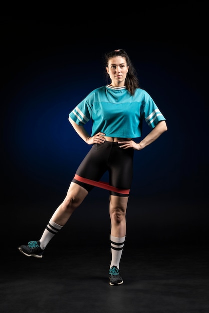 Female rugby player in sportswear posing