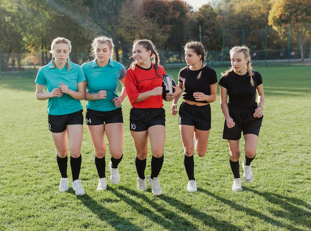 Free Photo female rugby team running with a ball