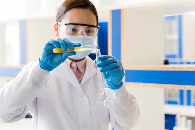 Female scientist in the lab with medical mask