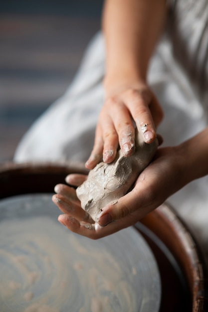 Female sculptor working with clay in the studio