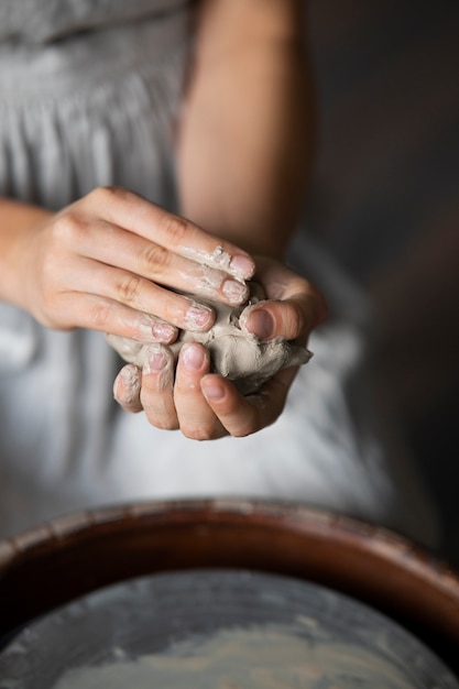 Female sculptor working with clay in the studio