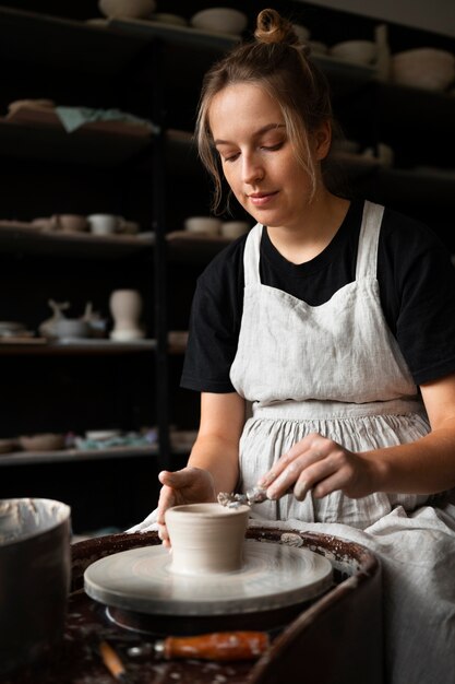 Female sculptor working with clay in the studio