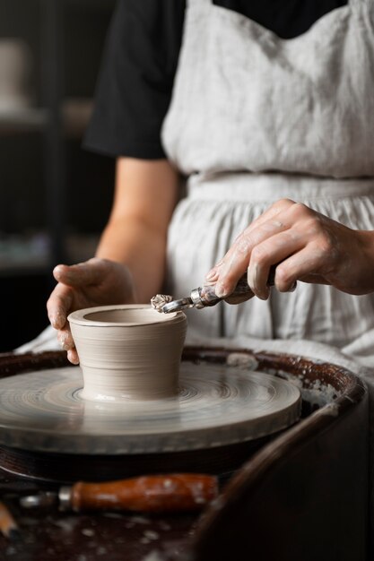 Female sculptor working with clay in the studio