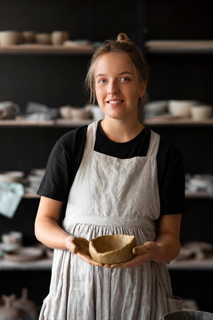 Female sculptor working with clay in the studio