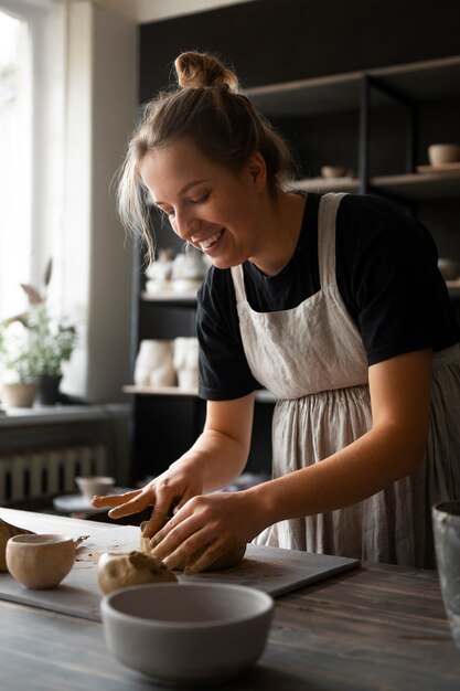 Female sculptor working with clay in the studio