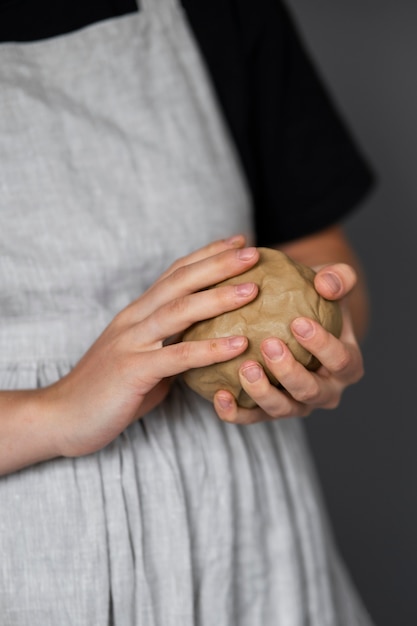 Female sculptor working with clay in the studio