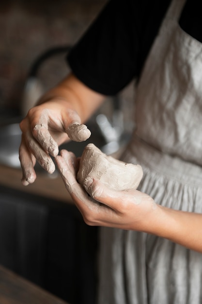 Female sculptor working with clay in the studio