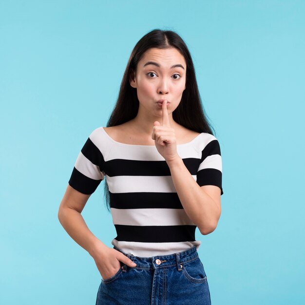 Female showing silence sign