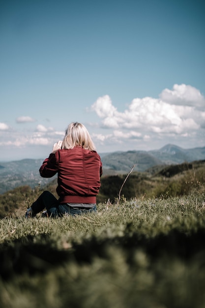 Female sitting outdoors in a beautiful field in the countryside