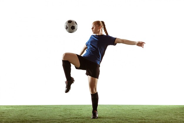 Female soccer, football player kicking ball, training in action and motion isolated on white background