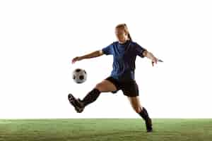 Free photo female soccer, football player kicking ball, training in action and motion isolated on white background