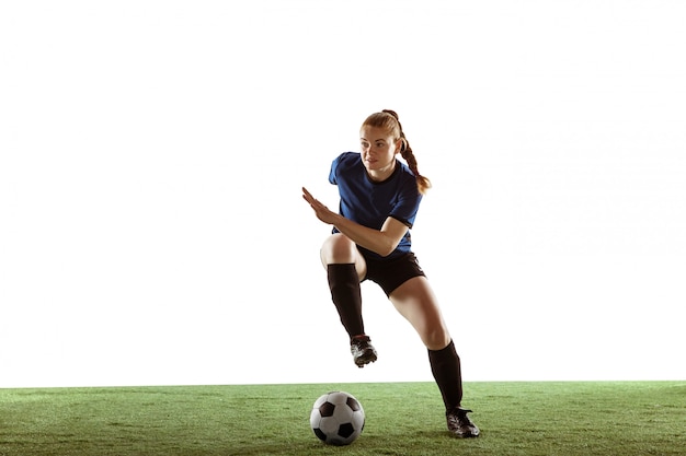 Female soccer, football player kicking ball, training in action and motion isolated on white background