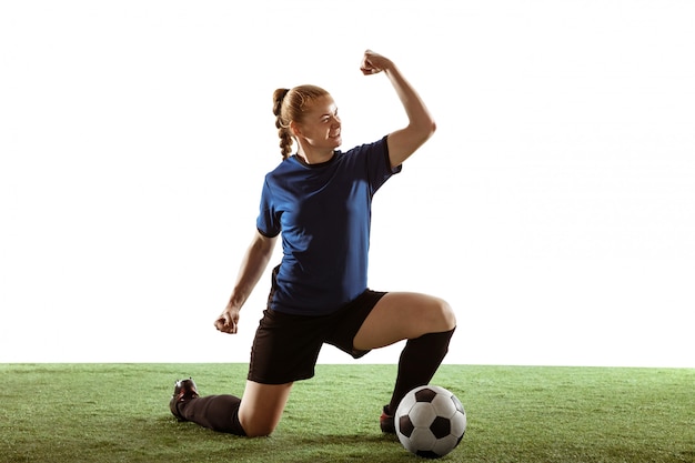 Free photo female soccer, football player kicking ball, training in action and motion isolated on white background