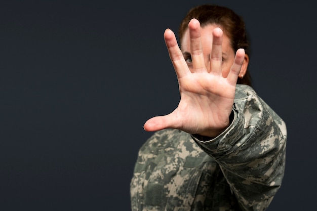 Free Photo female soldier reaching out her hand