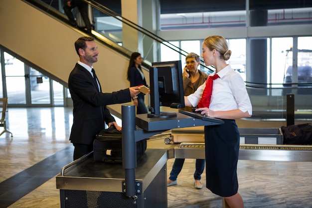 Free photo female staff interacting with passenger