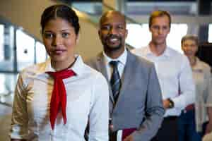 Free photo female staff and passengers standing in the airport terminal