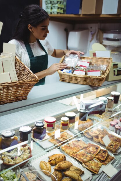 Female staff working at food counter