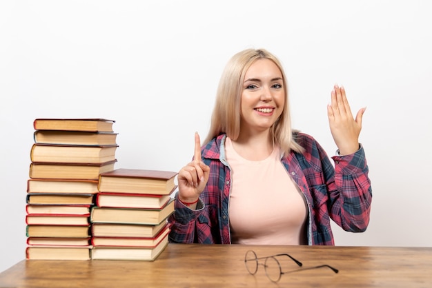 female student just sitting with books and smile on white