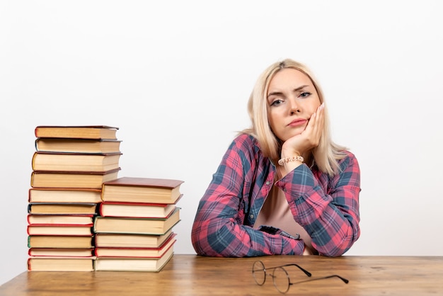 Free photo female student just sitting with books on white