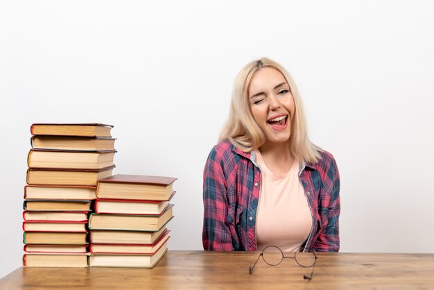 Free Photo female student just sitting with different books on white