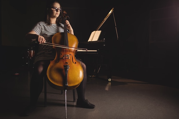 Free Photo female student playing double bass