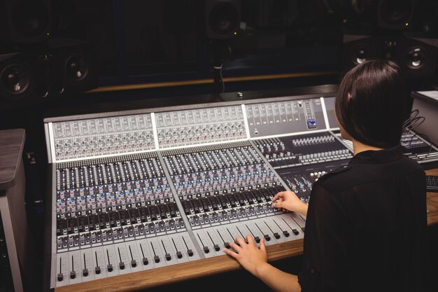 Female student using sound mixer