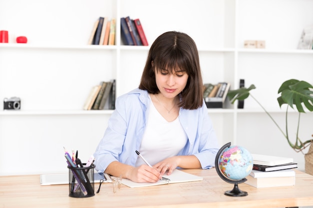 Female student writing in notebook