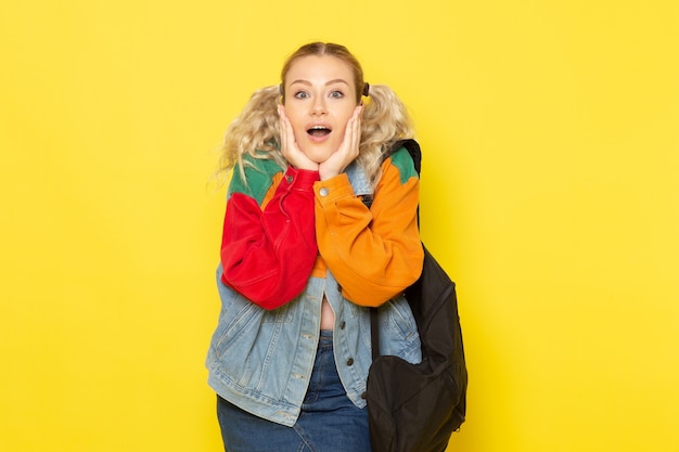 Free Photo female student young in modern clothes just simply posing with surprised expression on yellow