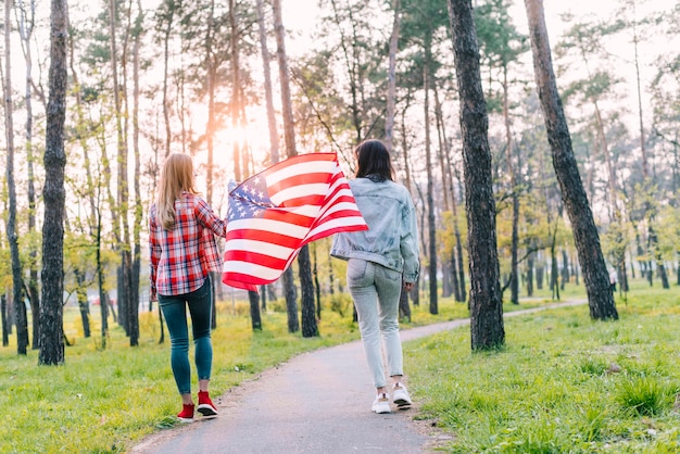 Free photo female students with flag of usa in park