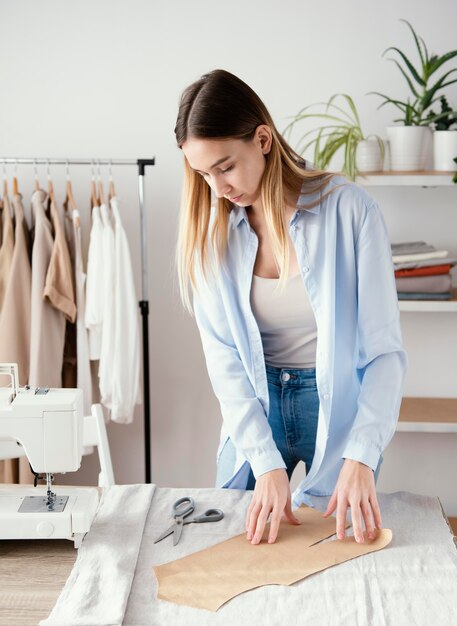 Female tailor preparing fabric for garments