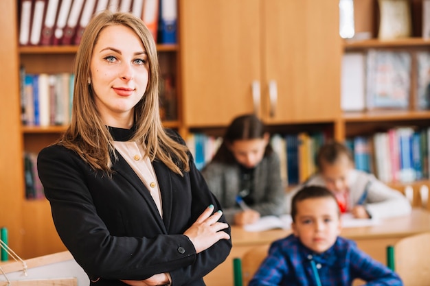 Female teacher on blurred background of classroom