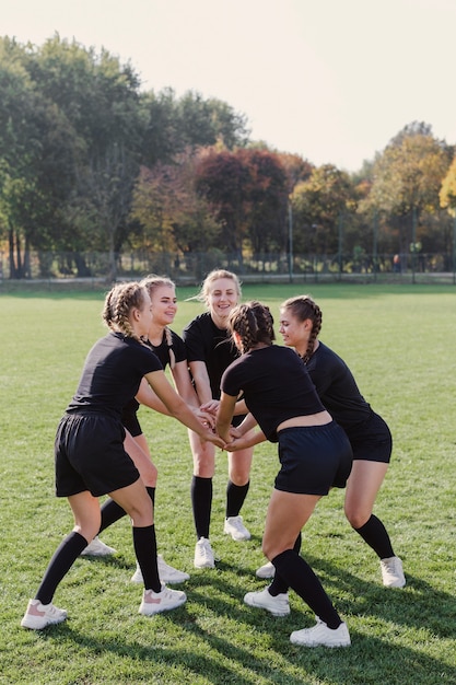 Free photo female team  girls putting hands together