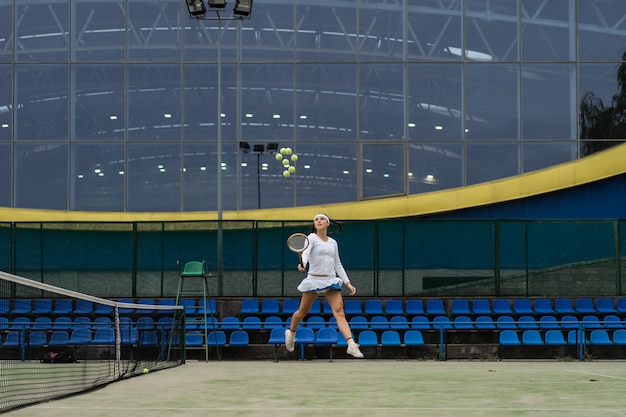 Female tennis player on green court grass