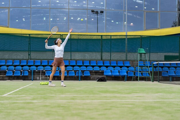 Female tennis player on green court grass