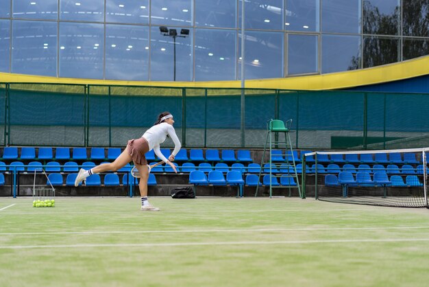 Female tennis player on green court grass