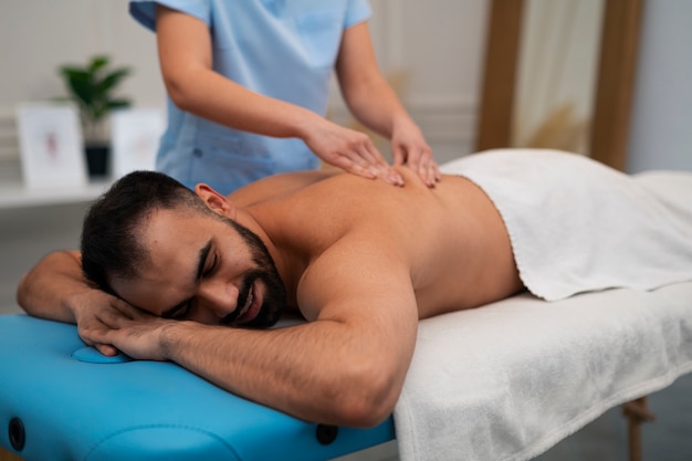 Female therapist in the rehabilitation center giving back massage