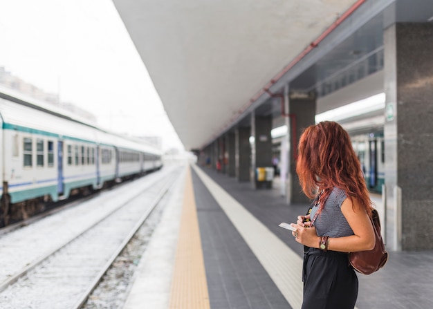 Female tourist waiting for train