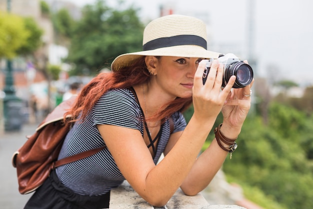 Free photo female tourist with camera on balcony