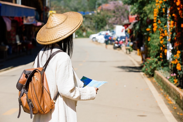 Female tourists on hand have a happy travel map.